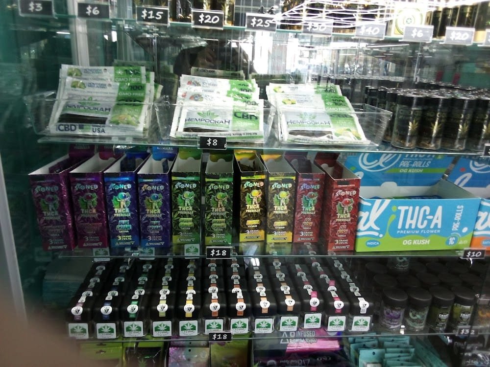 THCA and CBD display case featuring Stoned brand THCA pre-rolls in Indica, Sativa and Hybrid, Hempookah CBD pre-rolls, and iK THCA Premium Flower OG Kush
